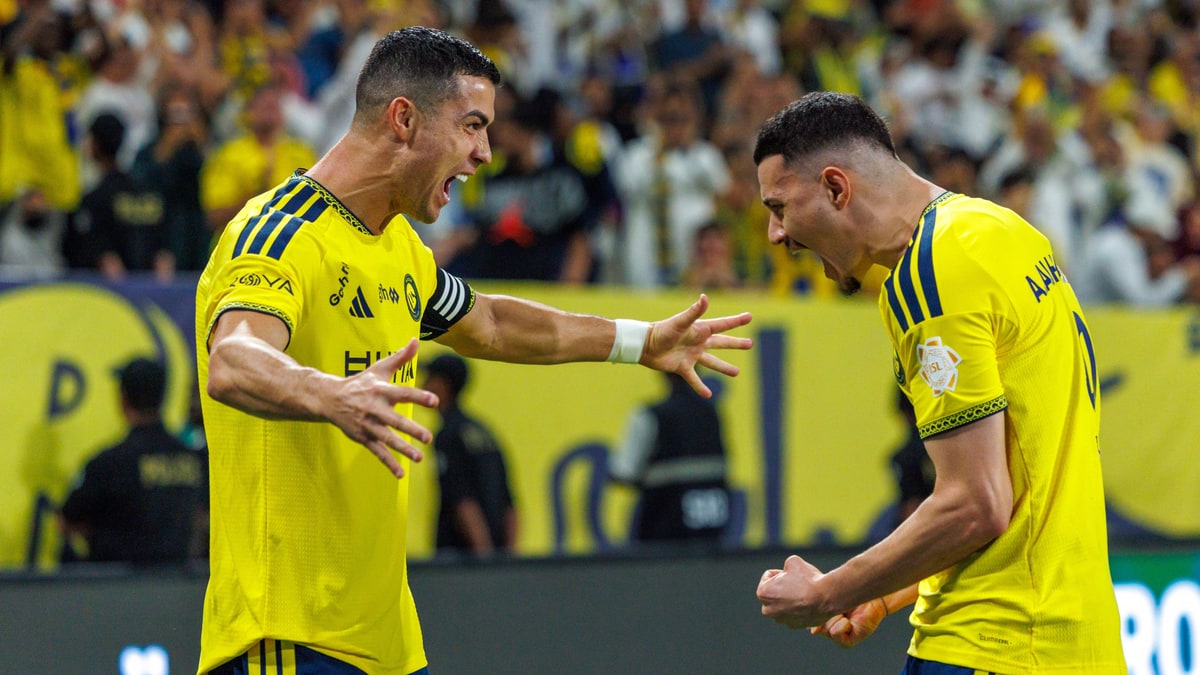 Cristiano Ronaldo celebrates a goal with an Al-Nassr teammate in front of the home crowd