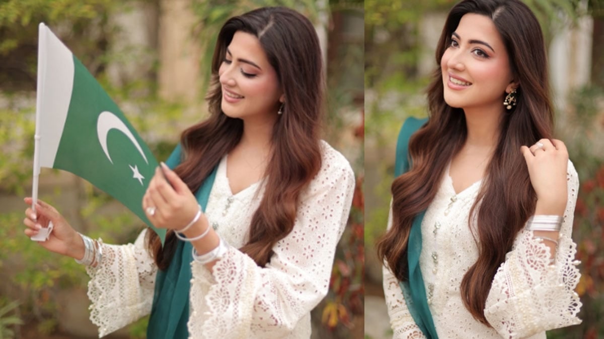 Aymen Saleem in a white outfit holding a small Pakistani flag, from her Instagram
