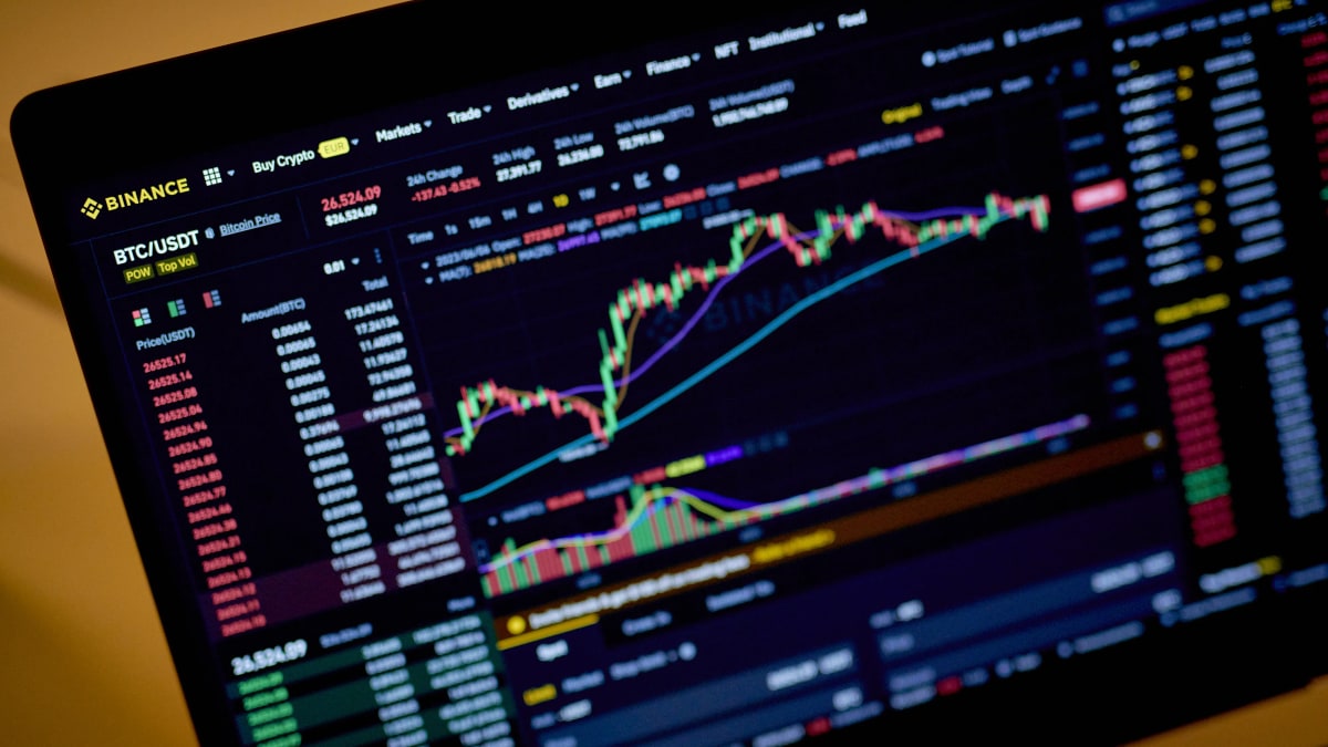 A laptop screen showing the Binance exchange's BTC/USDT trading chart