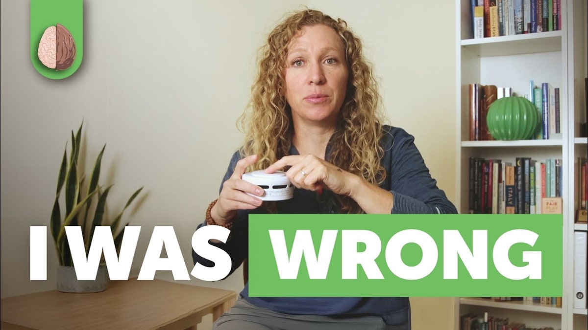Therapist Emma McAdam holding a smoke alarm in her video thumbnail captioned I was wrong