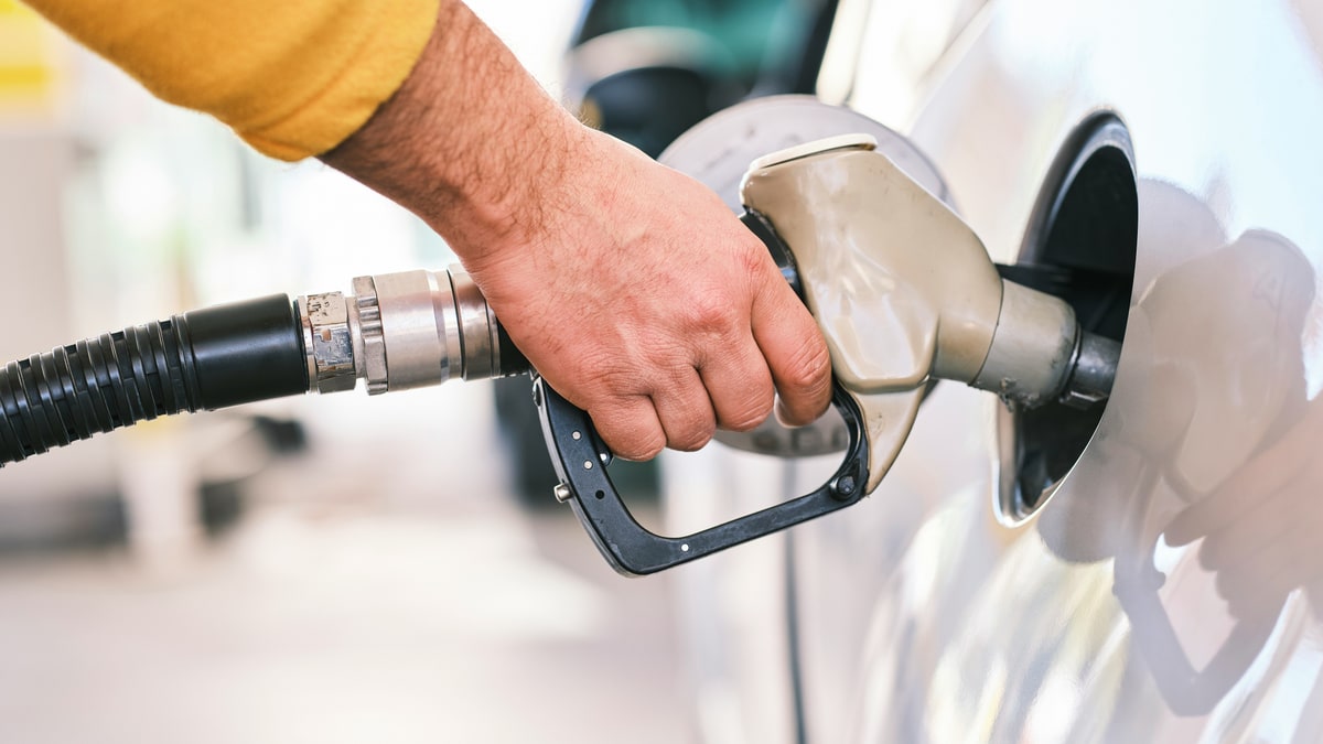 A driver fills a car with fuel at a pump