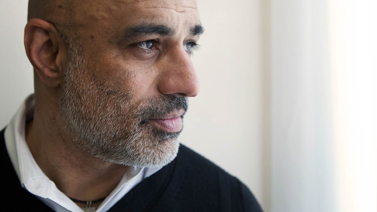 Close-up portrait of actor Faran Tahir in 2016, looking to the right