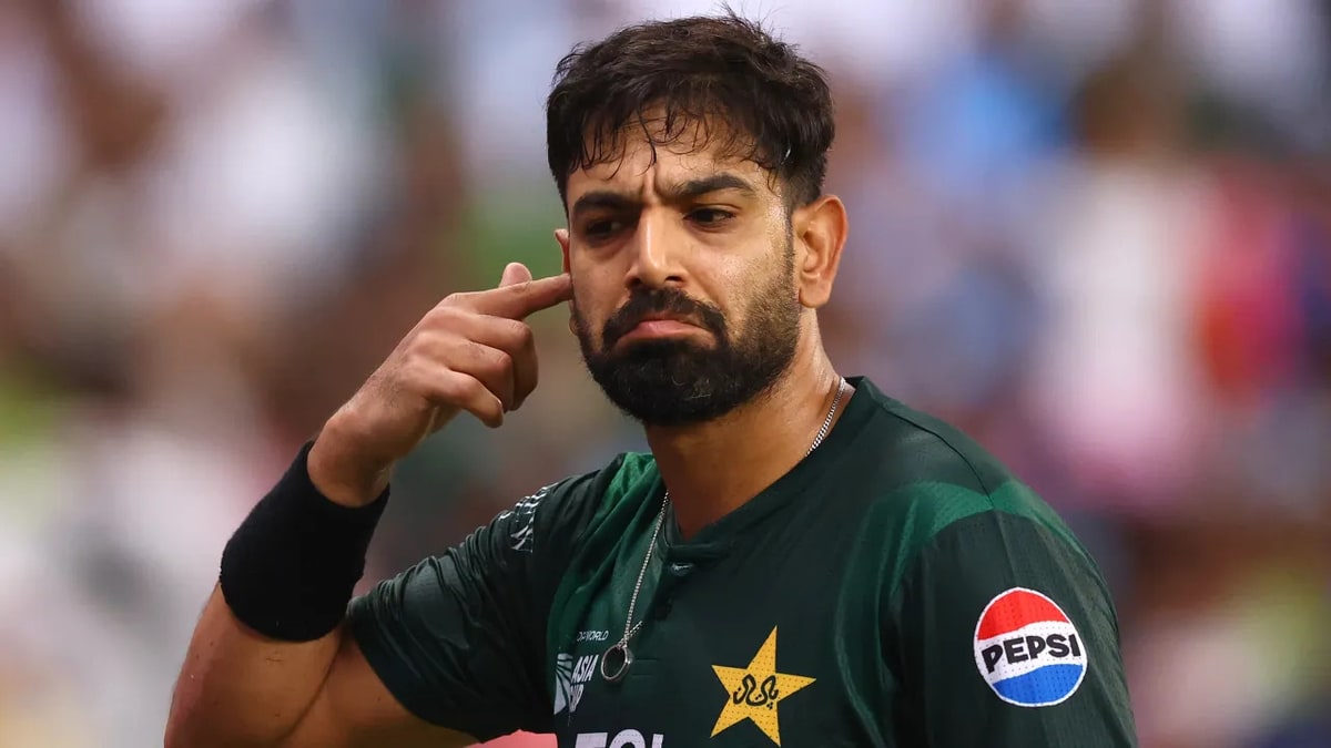 Haris Rauf in Pakistan kit touching his temple during a match