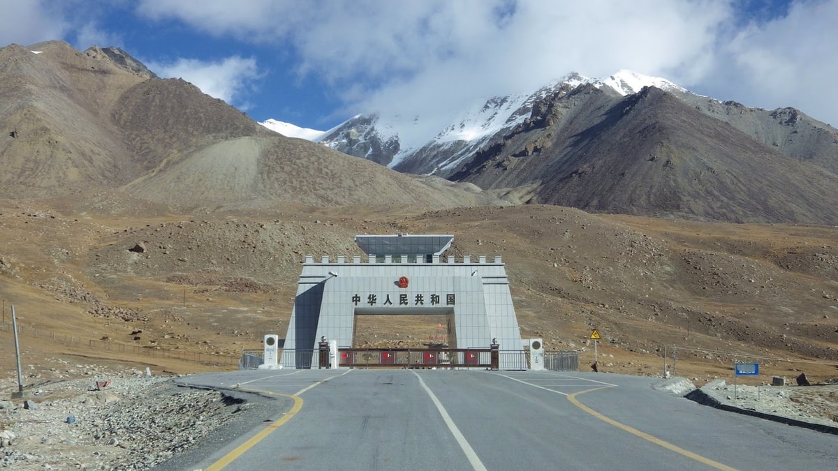 The Khunjerab Pass border gate on the Karakoram Highway below snow-capped mountains