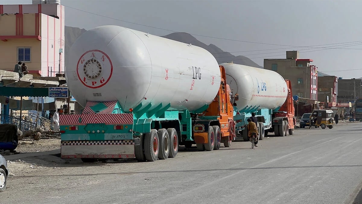Two LPG tanker trucks parked by a roadside in Pakistan