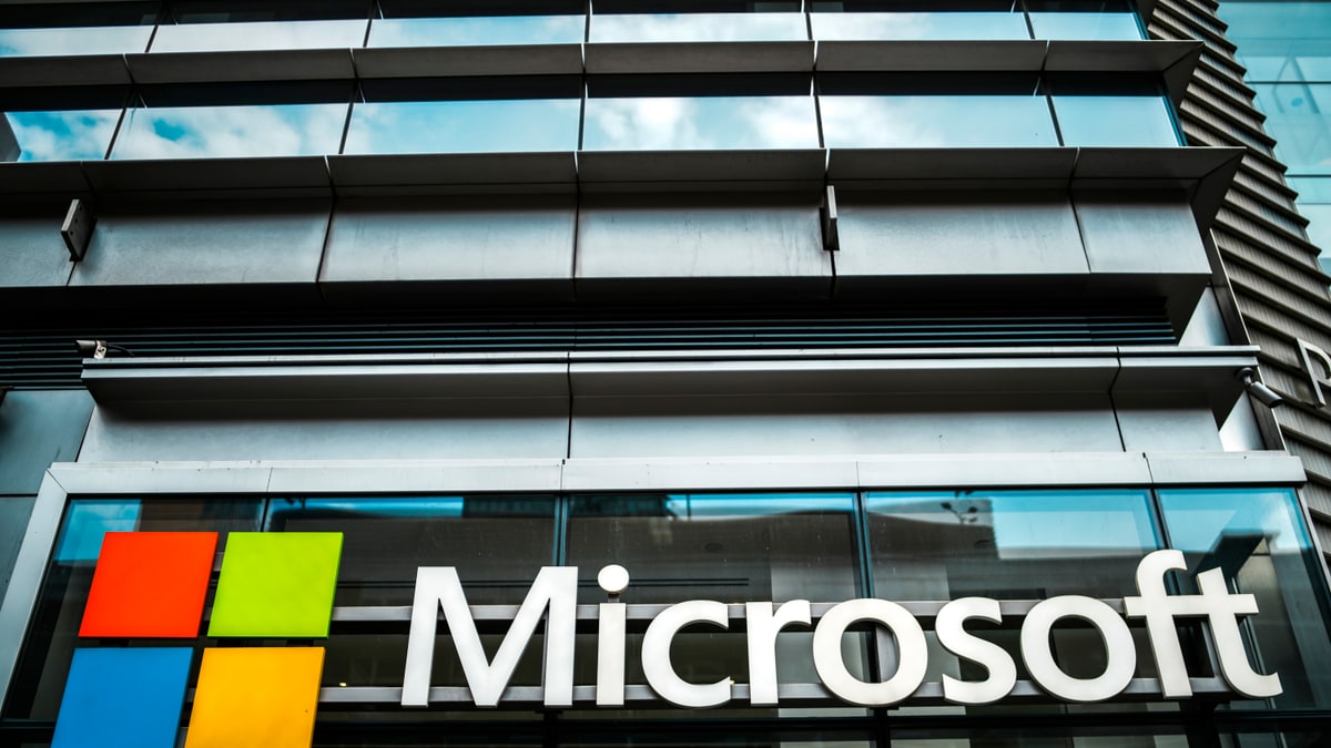 Microsoft logo and sign on the glass front of a company office building
