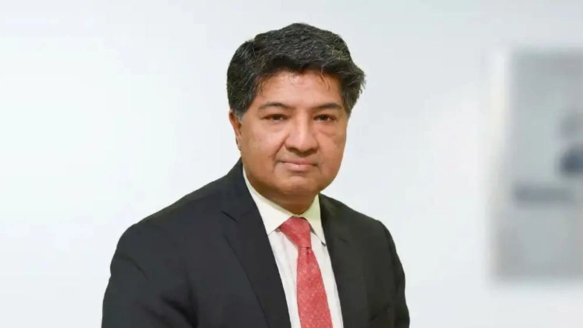 Portrait of NBP President and CEO Imran Sarwar in a dark suit and red tie