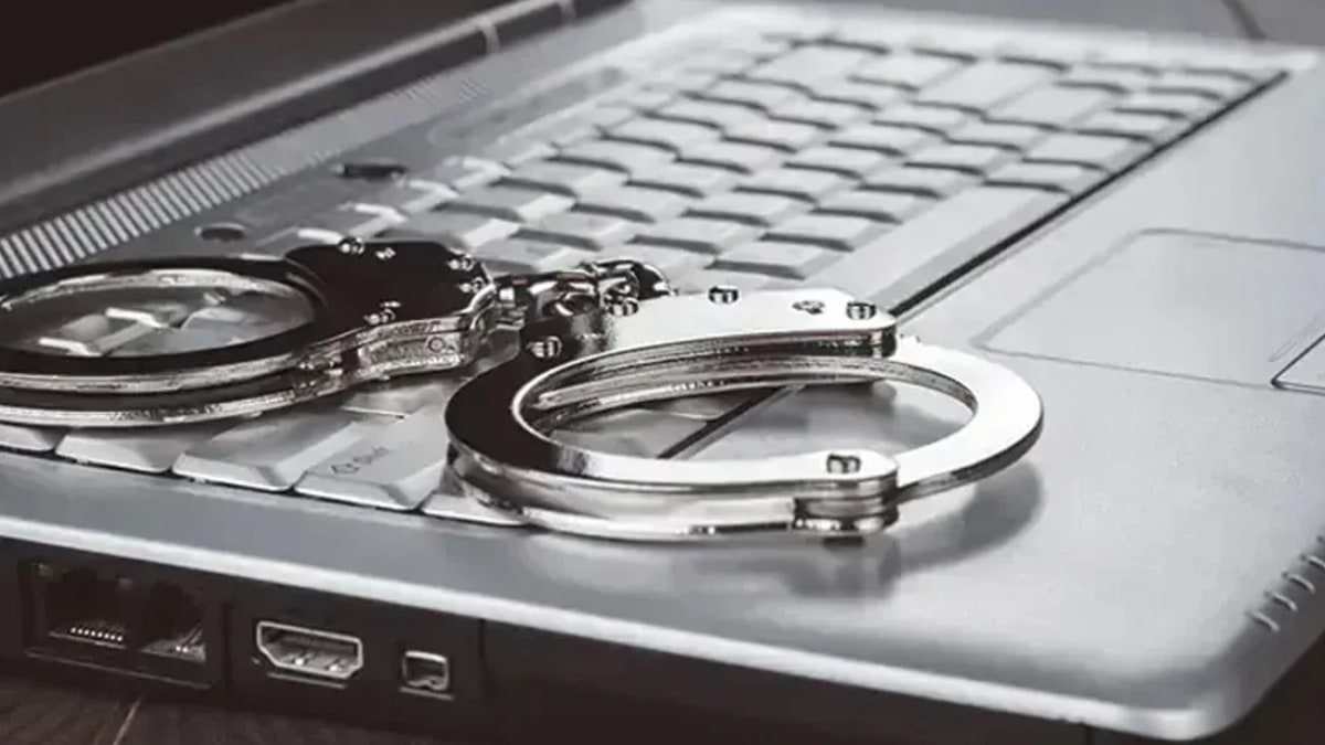 Handcuffs resting on a laptop keyboard