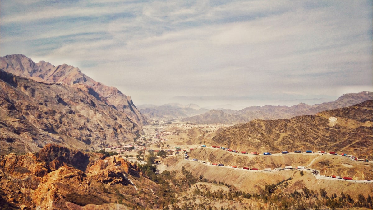 Lines of cargo trucks on the mountain road leading to the Torkham border crossing