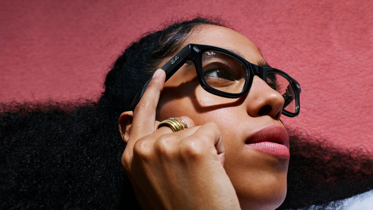 A model wearing Ray-Ban Meta smart glasses with a small camera in the frame, in a Meta promotional photo