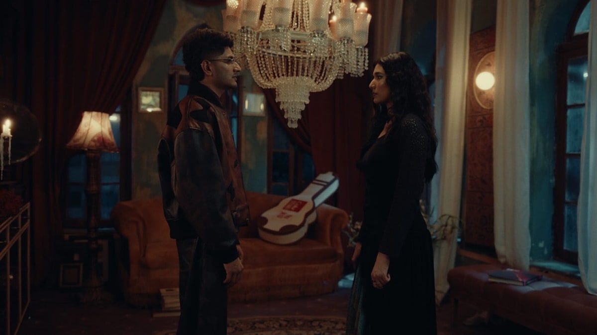 A man and a woman facing each other in a candle-lit room in a still from the Coke Studio Nu.WAV Qasam teaser