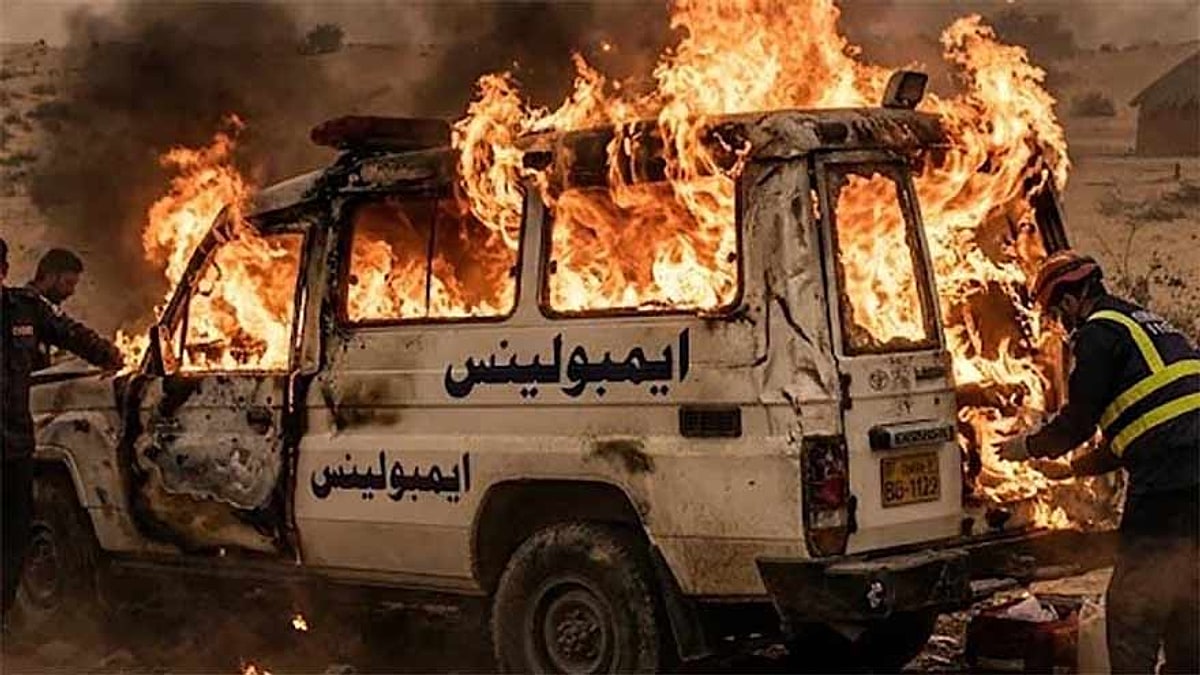 Rescue workers beside the burning PPHI ambulance in Tharparkar